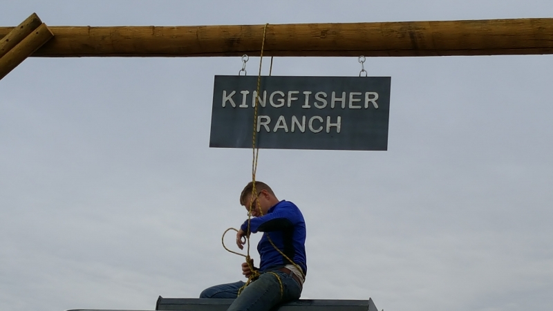 Staff hanging new Kingfisher Ranch sign
