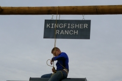 Staff hanging new Kingfisher Ranch sign
